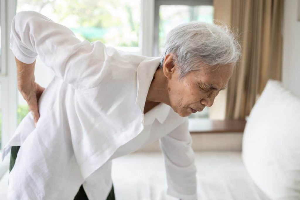 Sad asian senior woman with back and hip joint painful while standing
